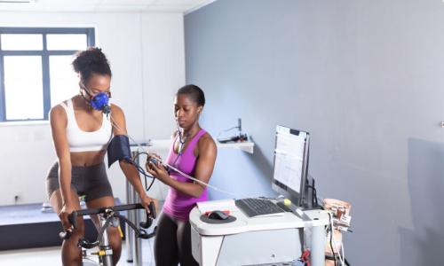 Woman training on a bike in a lab.